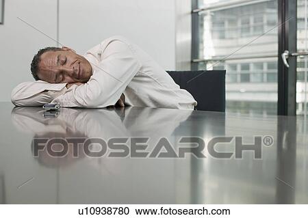 man leaing on table eyes closed View Large Photo Image Stock Image - man leaing on table eyes closed. Fotosearch