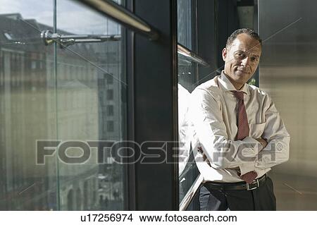 man leaning at window smiling View Large Photo Image Picture - man leaning at window smiling. Fotosearch