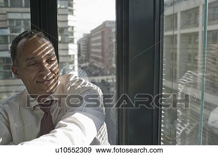 man leaning at window smiling View Large Photo Image Stock Photo - man leaning at window smiling. Fotosearch