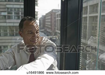 man leaning at window smiling View Large Photo Image Stock Photograph - man leaning at window smiling. Fotosearch