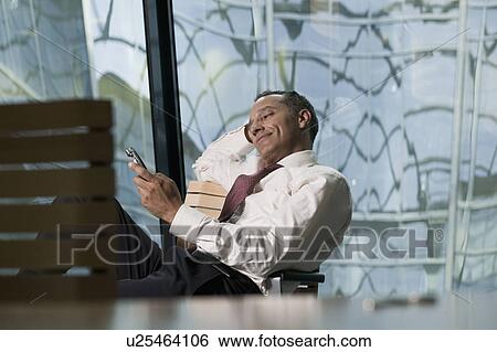 man leaning back in chair smiling View Large Photo Image Stock Photograph - man leaning back in chair smiling. Fotosearch