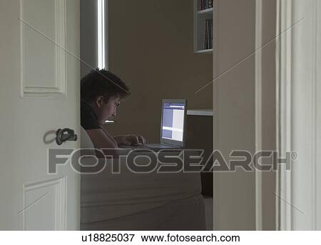 Man looking at laptop View Large Photo Image Stock Photo - Man looking at laptop. Fotosearch