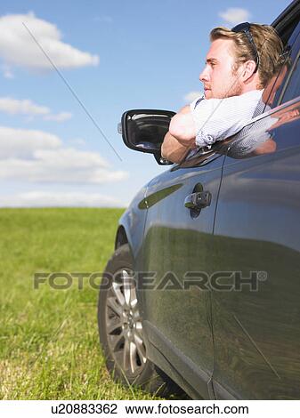 man looking out of car window View Large Photo Image Stock Image - man looking out of car window. Fotosearch