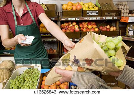 man paying shopkeeper for fruit View Large Photo Image Stock Image - man paying shopkeeper for fruit. Fotosearch