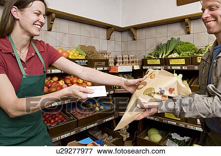 man paying shopkeeper for fruit View Large Photo Image Stock Photo - man paying shopkeeper for fruit. Fotosearch