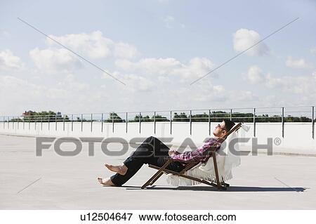 man relaxing in the sun View Large Photo Image Stock Photo - man relaxing in the sun. Fotosearch