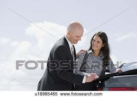 man signing contract on back of car View Large Photo Image Stock Photography - man signing contract on back of car. Fotosearch