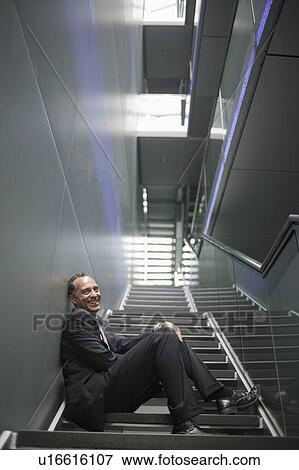 man sitting on stair steps smiling View Large Photo Image Stock Photo - man sitting on stair steps smiling. Fotosearch