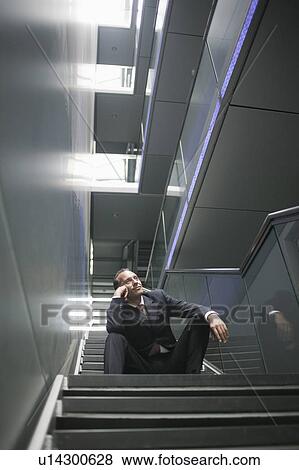 Stock Photo - man sitting on stair steps. Fotosearch
