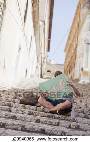 Man sitting on stairs reading map View Large Photo Image Stock Photography - Man sitting on stairs reading map. Fotosearch