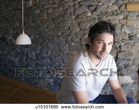 man sitting on table in chalet View Large Photo Image Stock Photography - man sitting on table in chalet. Fotosearch