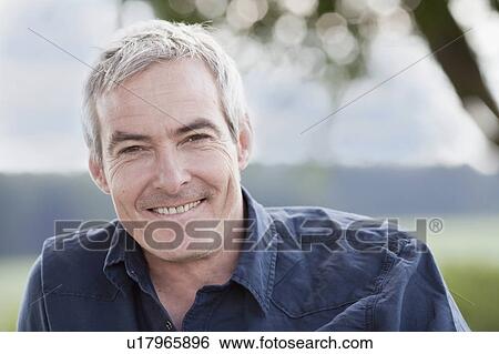 Stock Photograph - man sitting smiling at viewer. Fotosearch