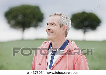 Picture - Man smiling into distance. Fotosearch