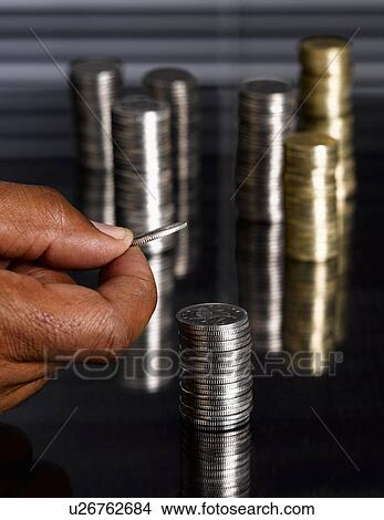 Man stacking sterling coins View Large Photo Image Picture - Man stacking sterling coins. Fotosearch