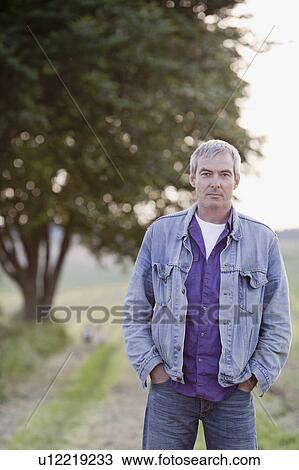 man standing at a road looking at viewer View Large Photo Image Stock Image - man standing at a road looking at viewer. Fotosearch