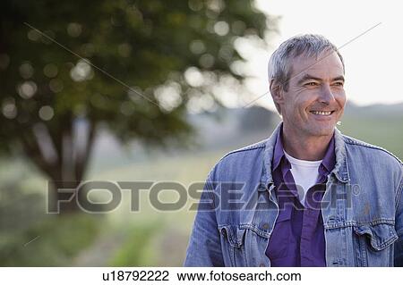 man standing at a road smiling View Large Photo Image Stock Image - man standing at a road smiling. Fotosearch