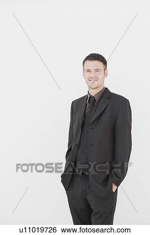 man standing in front of white wall View Large Photo Image Stock Photograph - man standing in front of white wall. Fotosearch