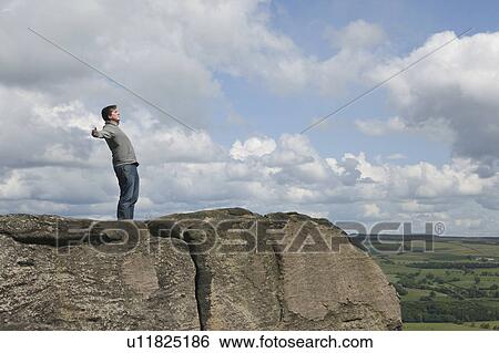 Stock Photograph - Man standing in wind. Fotosearch