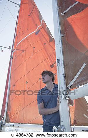man standing on a boat smiling View Large Photo Image Stock Image - man standing on a boat smiling. Fotosearch