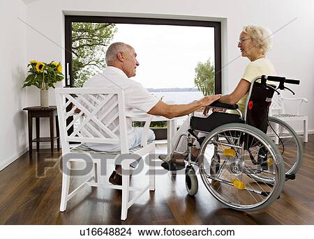man touching woman in wheelchair View Large Photo Image Picture - man touching woman in wheelchair. Fotosearch
