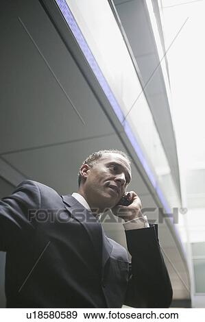 Stock Photo - man using cell phone. Fotosearch
