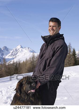man with dog up on snowy mountain View Large Photo Image Stock Image - man with dog up on snowy mountain. Fotosearch