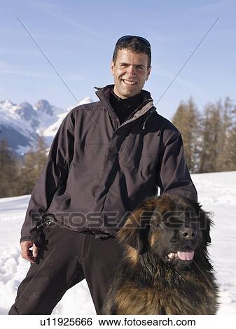 man with dog up on snowy mountain View Large Photo Image Stock Photograph - man with dog up on snowy mountain. Fotosearch