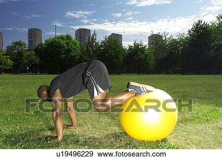 Stock Photo - man with gym ball. Fotosearch
