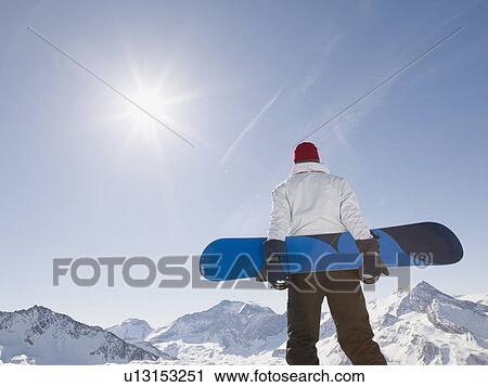man with snowboard on top of mountain View Large Photo Image Stock Image - man with snowboard on top of mountain. Fotosearch