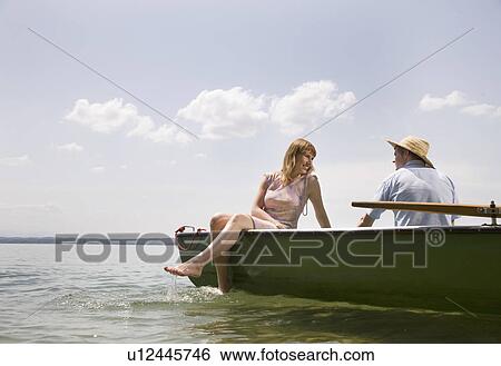 man, woman in rowing boat on lake View Large Photo Image Stock Photograph - man, woman in rowing boat on lake. Fotosearch