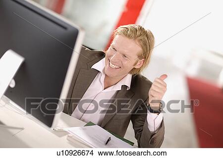 Picture - man working in an office. Fotosearch