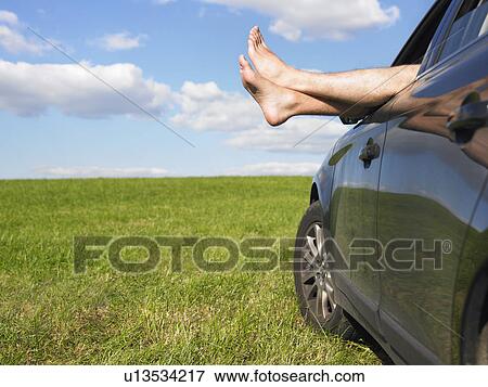 Stock Photo - mans feet out of car window. Fotosearch