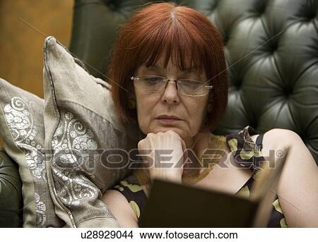 Picture - Mature Lady reading a book. Fotosearch