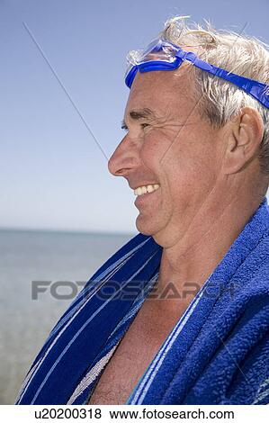 Stock Photo - Mature man after swimming. Fotosearch