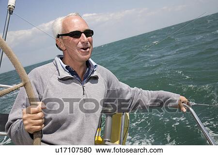 Mature man sailing yacht View Large Photo Image Stock Image - Mature man sailing yacht. Fotosearch