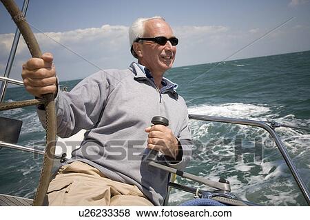 Mature man sailing yacht View Large Photo Image Stock Photo - Mature man sailing yacht. Fotosearch