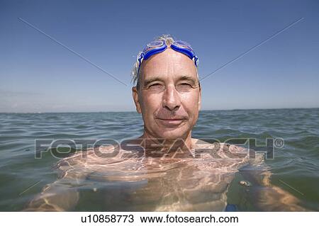 Stock Image - Mature man swimming. Fotosearch