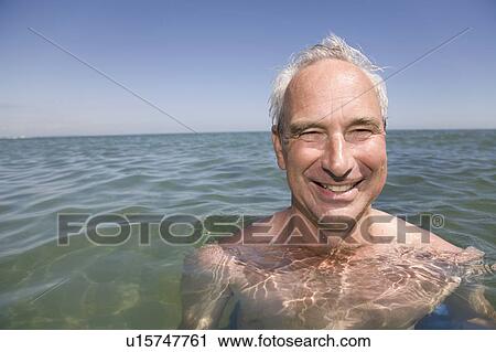 Stock Image - Mature man swimming. Fotosearch