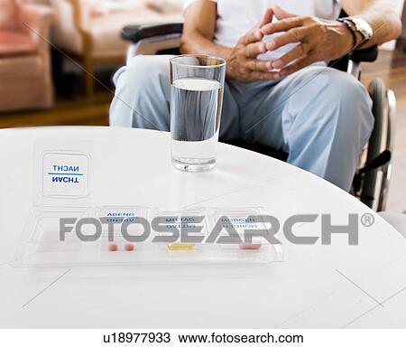 Stock Image - medicine, water and man in wheelchair. Fotosearch