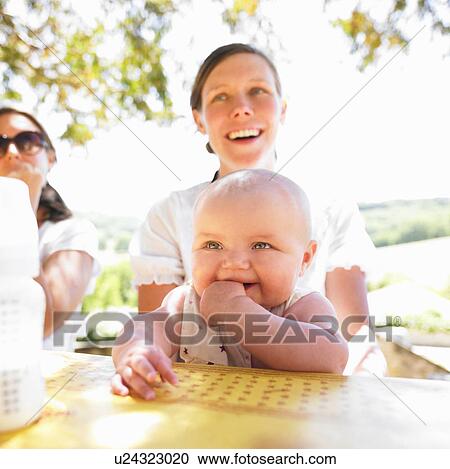 Stock Image - mother and baby at the table. Fotosearch