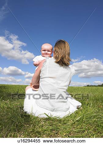 Stock Photography - mother and baby in field. Fotosearch