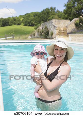 Picture - mother and baby in pool. Fotosearch