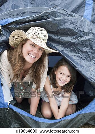 Stock Image - Mother and child emerging from tent. Fotosearch