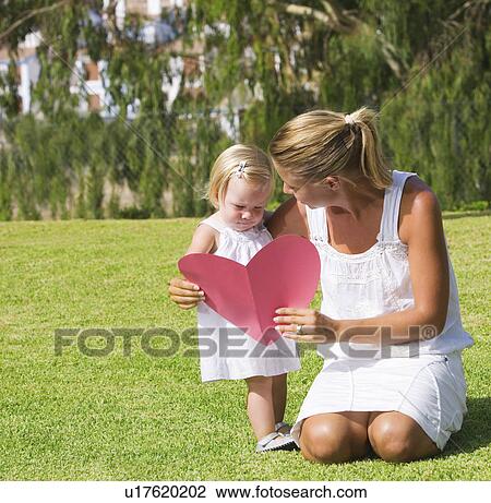 Mother and daughter holding paper heart View Large Photo Image Stock Image - Mother and daughter holding paper heart. Fotosearch