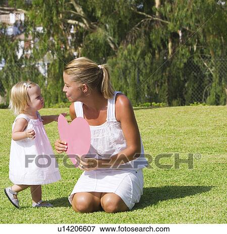 Mother and daughter holding paper heart View Large Photo Image Stock Photo - Mother and daughter holding paper heart. Fotosearch
