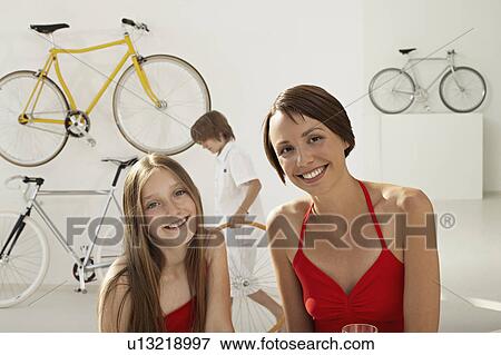 Stock Photo - mother and daughter in bikestore. Fotosearch