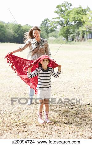 Picture - Mother and daughter in country field. Fotosearch