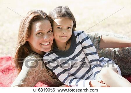 Mother and daughter lie on red blanket View Large Photo Image Stock Photograph - Mother and daughter lie on red blanket. Fotosearch