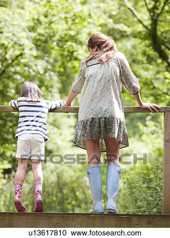 Mother and daughter looking over railing View Large Photo Image Stock Image - Mother and daughter looking over railing. Fotosearch