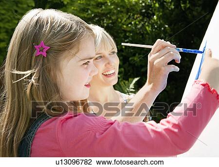 Mother and daughter painting together View Large Photo Image Stock Image - Mother and daughter painting together. Fotosearch
